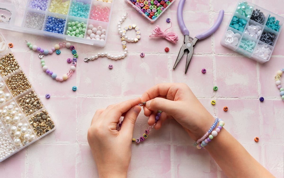A child creating handmade crafts at a table, enjoying a relaxing hobby