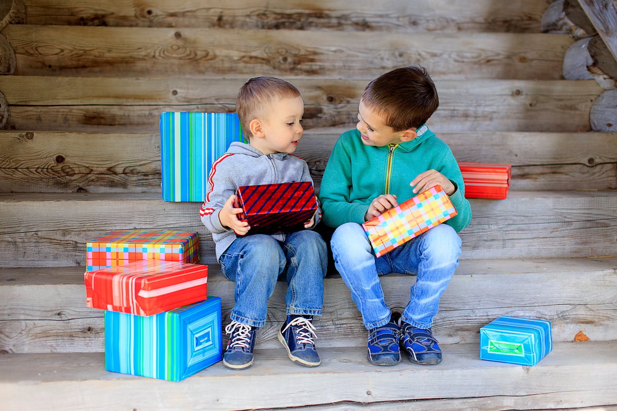 Two little brothers lovingly exchanging gifts